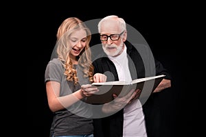 Grandfather and granddaughter with book