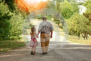 Grandfather with the granddaughter  go on the road