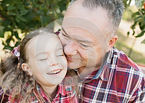 grandfather with granddaughter. Multi generation family enjoying in the park