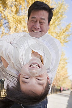 Grandfather and Granddaughter Playing in the Park