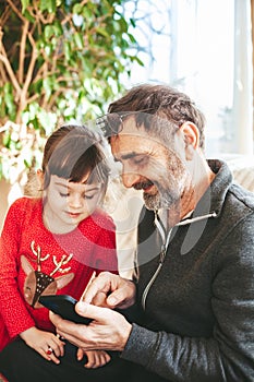 Grandfather and granddaughter using smartphone