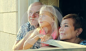 Grandfather and grandmother holding granddaughter