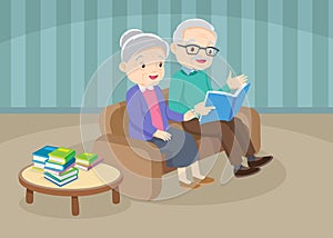 Grandfather with grandmother reading book together on sofa