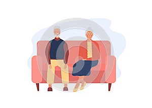 Grandfather and grandmother sitting on pink sofa together. Pensioners spending time together. Lonely old age couple