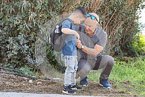 Grandfather and grandson going to school.