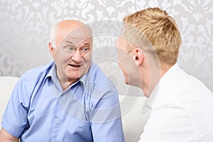 Grandfather and grandson having conversation