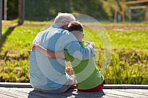 Grandfather and grandson hugging on berth