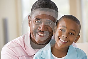 Grandfather and grandson indoors smiling