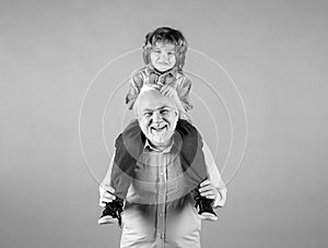 Grandfather and grandson piggy back ride with funny face isolated. Elderly old relative with child.