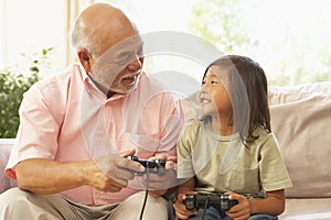 Grandfather And Grandson Playing Computer Game At