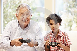 Grandfather and grandson playing computer games