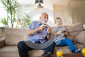 Grandfather and grandson are playing video games