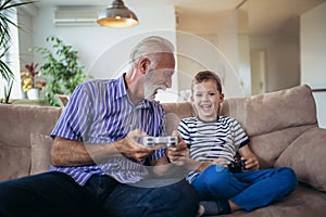 Grandfather and grandson are playing video games