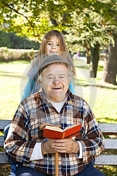 Grandfather and grandson reading book