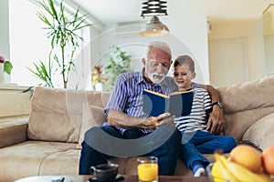 Grandfather With Grandson Reading Together