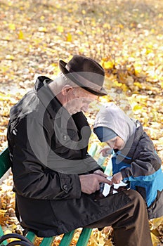 Grandfather and grandson sharing a tablet-pc