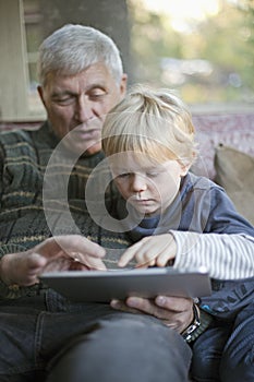 Grandfather and grandson using Tablet PC