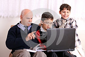 Grandfather, grandsons and notebook