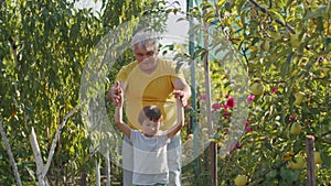 Grandfather guiding a young child through a lush garden. Family togetherness and nature education concept. Design for