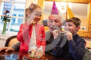 Grandfather having a party with his grandchildren