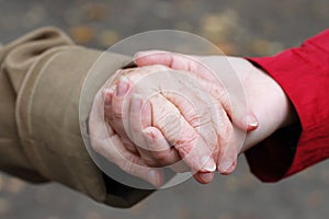 Grandfather holding his grand daughter hand