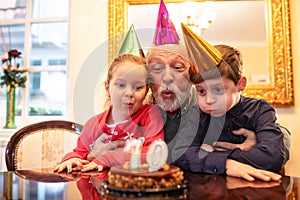 Grandfather holding and hugging his grandchildren