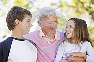 Grandfather laughing with grandchildren
