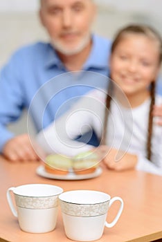 Grandfather and little girl having tea party