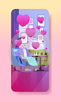 grandfather in love playing chess senior man sitting in armchair valentines day celebration concept living room interior