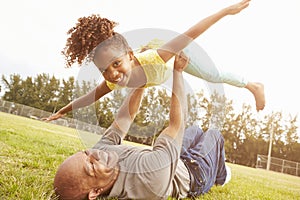 Grandfather Playing Game With Granddaughter In Park photo