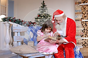 Grandfather playing Santa Claus role for granddaughter.