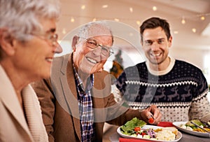 Grandfather, portrait and family at dinner on Christmas together with food and celebration in home. Happy, event and old