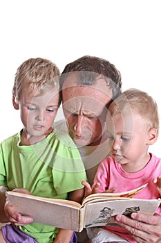 Grandfather read book with children