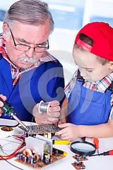 Grandfather showing PCB soldering to grandchild