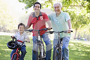 Grandfather son and grandson bike riding