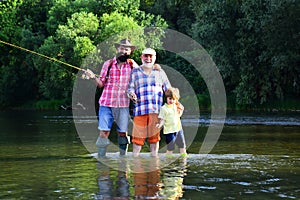 Grandfather with son and grandson having fun in river. Happy fathers day. Grandson with father and grandfather fishing