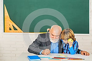 Grandfather talking to son. World teachers day. Educational process. Man with old teacher learning in class on color