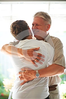 Grandfather, teenager and hug with smile, family and embrace with love, grandchild and home. Grandparent, support or