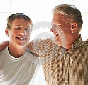 Grandfather, teenager and hug with smile, happy and embrace with love, grandchild and home. Grandparent, support or