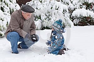 Grandfather and toddler boy on winter day