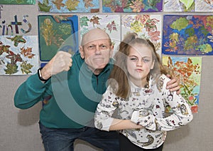 Grandfather in tough guys pose with granddaughter