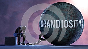 Grandiosity and an alienated suffering human. A metaphor showing Grandiosity as a huge prisoner's ball bringing pain and photo