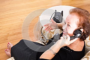 Grandma chatting on an old rotary telephone