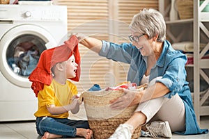 Grandma and child are doing laundry photo