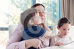 Grandma entertaining her little grandchildren with a tablet computer game