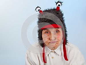 Grandma in funny hat with a sulky expression