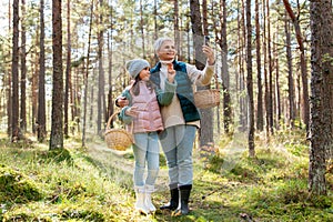 grandma with granddaughter taking selfie in forest