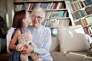 Grandma having a lovely time with her little granddaughter while playing at home together. Family, leisure, together