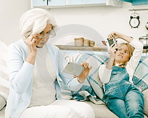 Grandma And Her Grandchild Cannot Understand Each Other`s Gadgets Making Photos