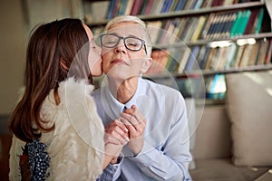 Grandma and her little granddaughter are full of emotions while spending quality time at home together. Family, leisure, together